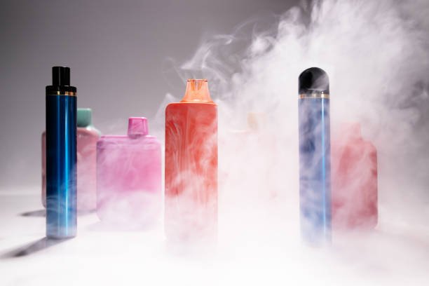 A colorful collection of various vape juice bottles with different flavors arranged on a table