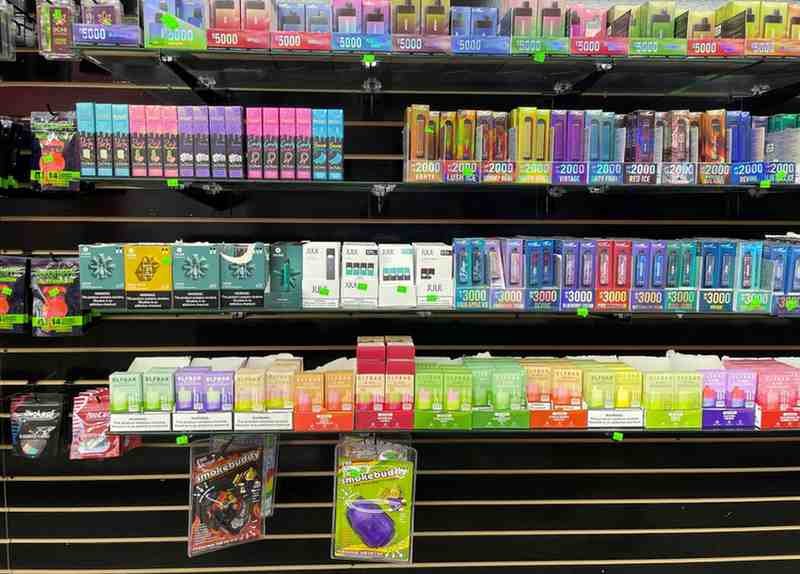 Modern vape shop with a wide range of vaping products and customers exploring devices