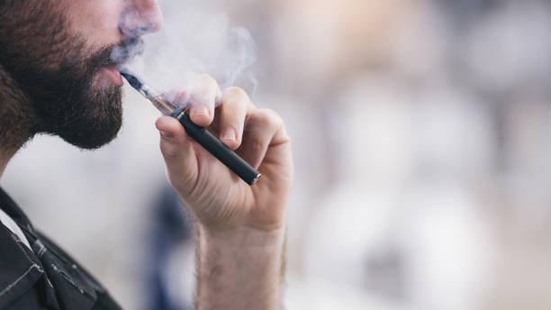Kid disposing of trash properly, reminding vapers to recycle disposable vapes in Australia.