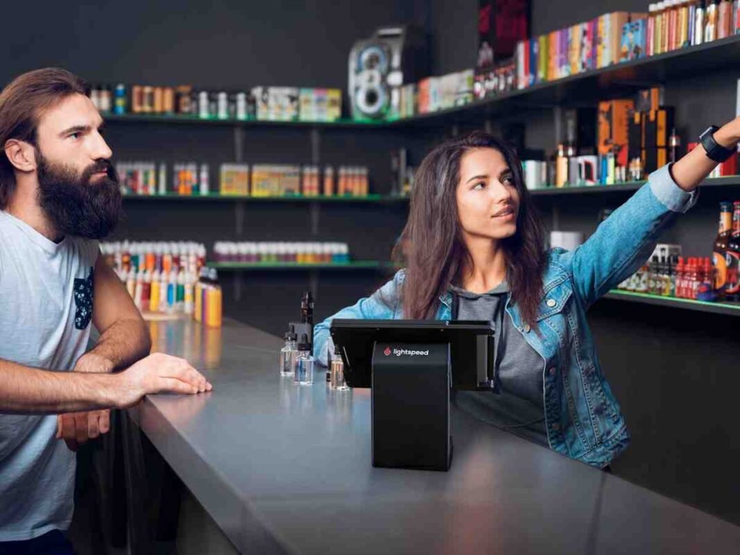 Interior of a modern vape shop with shelves of e-liquids, devices, and accessories