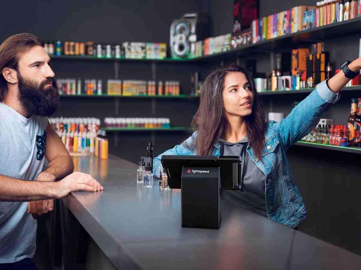 Interior of a modern vape shop with shelves of e-liquids, devices, and accessories